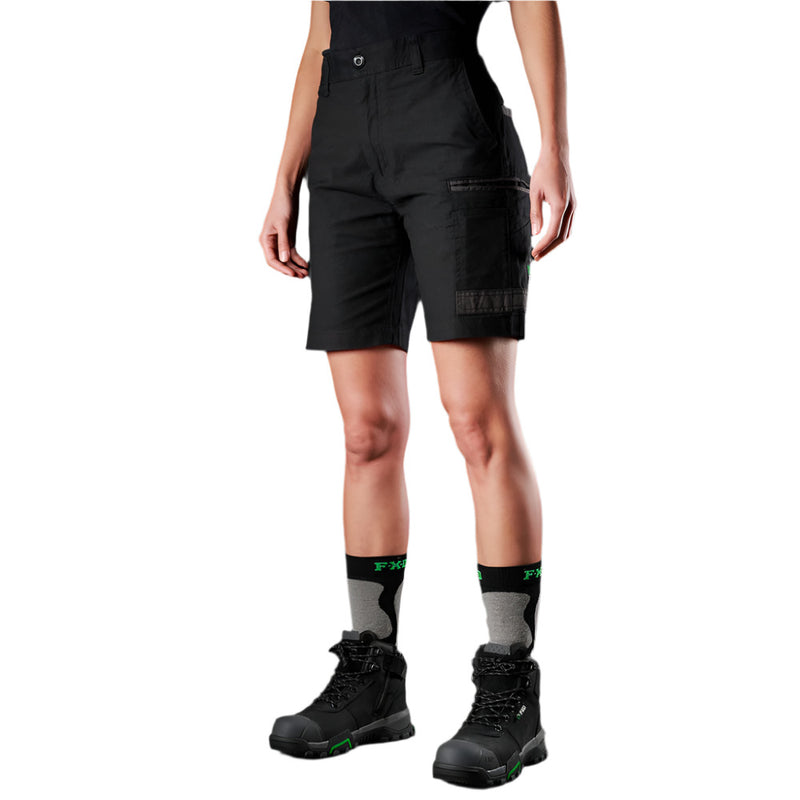 Load image into Gallery viewer, Model wears FXD WS-3W Women's Stretch Work Short, featuring belt loops, multiple pockets, and a durable design. Paired with black mid-calf socks and work boots, showcasing practical workwear for women tradies.