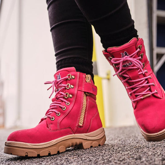 A pink pair of women's safety boots from Steel Blue. The work boots feature a zip side access for easy on and off and is part of Active Safety's wide women's safety footwear range.
