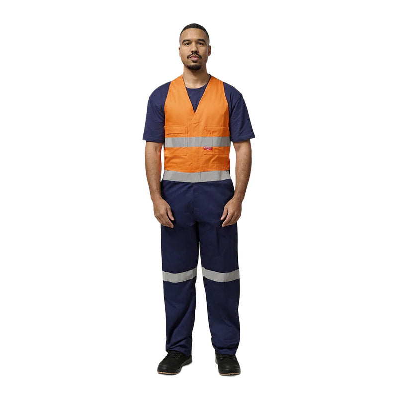 Load image into Gallery viewer, Man modeling Hard Yakka Easy Action Hi Vis Cotton Bib Overall, featuring reflective tape, elastic back waist, non-spill pockets, and durable construction, ideal for visibility and functionality on work sites.
