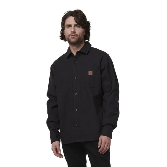 Hard Yakka Heritage Canvas L/S Shirt, Black features a regular fit with double chest pockets, buttoned-down placket, and durable stitching. Ideal for layering, its garment-washed cotton offers comfort and movement ease.