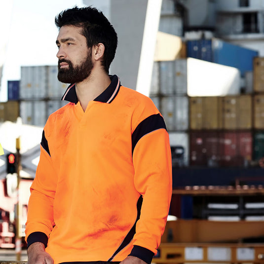 Syzmik Hi Vis Aztec L/S Polo Shirt modeled by a bearded man, showcasing its moisture-wicking, breathable fabric and button-free placket, designed for safety and comfort in active work environments.