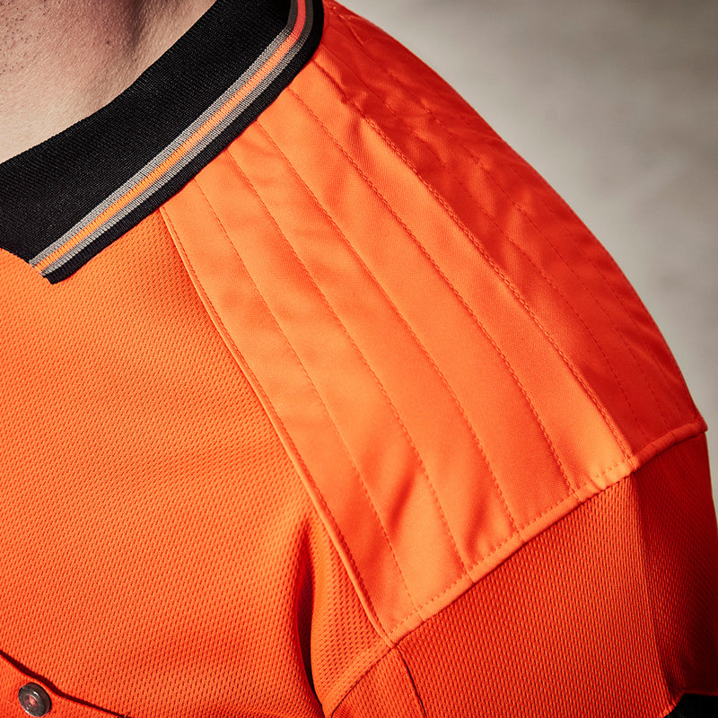 Load image into Gallery viewer, Syzmik Hi Vis Reinforced Squad Polo Shirt, featuring a close-up of its reinforced shoulder area with fleece padding and a chest pocket with pen insert, designed for comfort and durability.