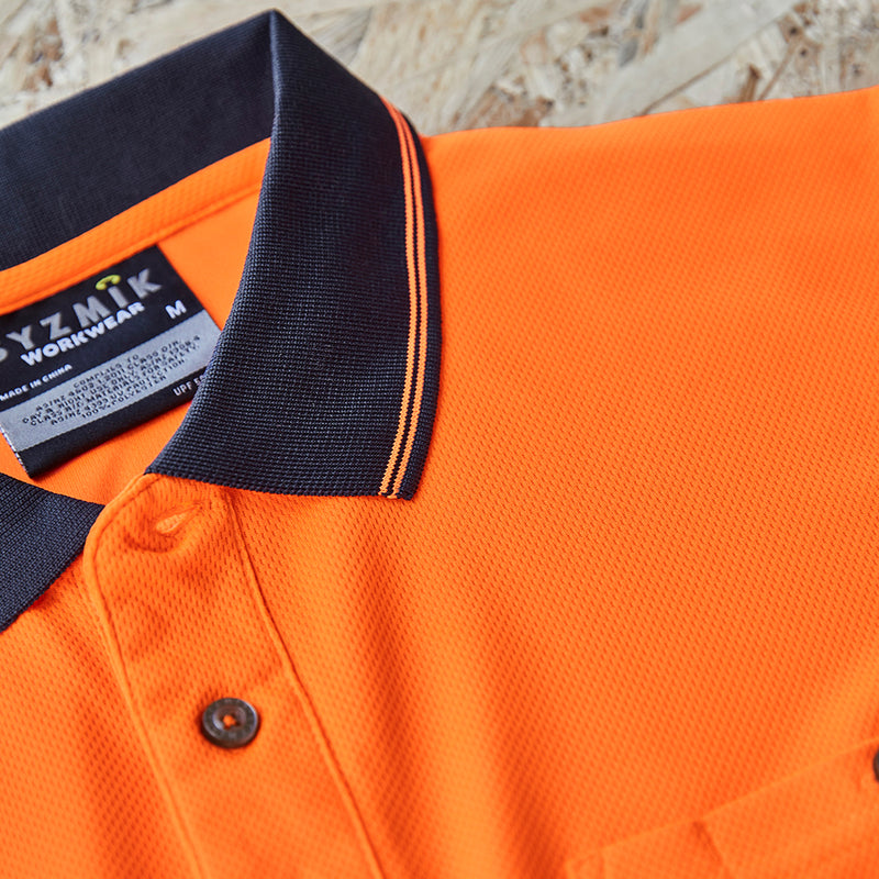 Load image into Gallery viewer, Syzmik Hi Vis Segmented Taped Polo Shirt featuring a black and orange design with a collar, button, and chest pocket with pen insert, highlighting moisture-wicking, breathable, and quick-dry fabric.