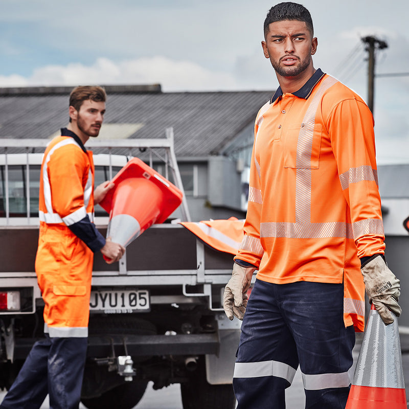 Load image into Gallery viewer, Syzmik Hi Vis TTMC-W Segmented Tape Polo Shirt worn by men in orange uniforms, showcasing its breathable, quick-dry fabric and chest pocket with pen insert, ideal for safety work environments.