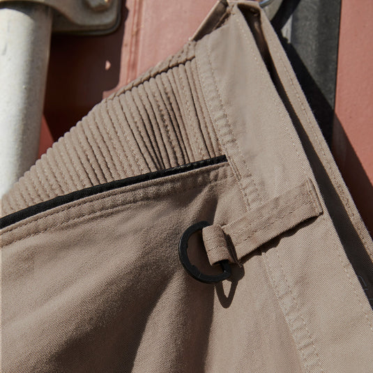 Syzmik Streetworx Stretch Pant features a modern slim fit with elastic cuff hem and black bonded zips. Enhanced with stretch pleating for comfort, the pants include multiple functional pockets for practical use.