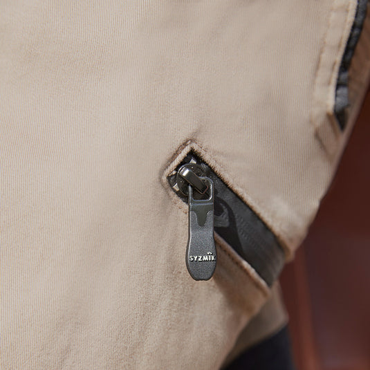 Syzmik Streetworx Stretch Pant featuring black bonded zips on large pockets and elastic cuff hem, designed for comfort and mobility with stretch pleating at key points for enhanced flexibility.