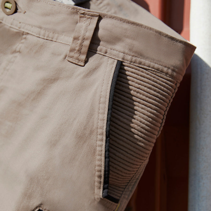 Load image into Gallery viewer, Syzmik Streetworx Stretch Pant, featuring a close-up of its modern slim fit design with elastic cuff hem, large black-zipped pockets, and stretch pleating for enhanced flexibility, ideal for workwear.