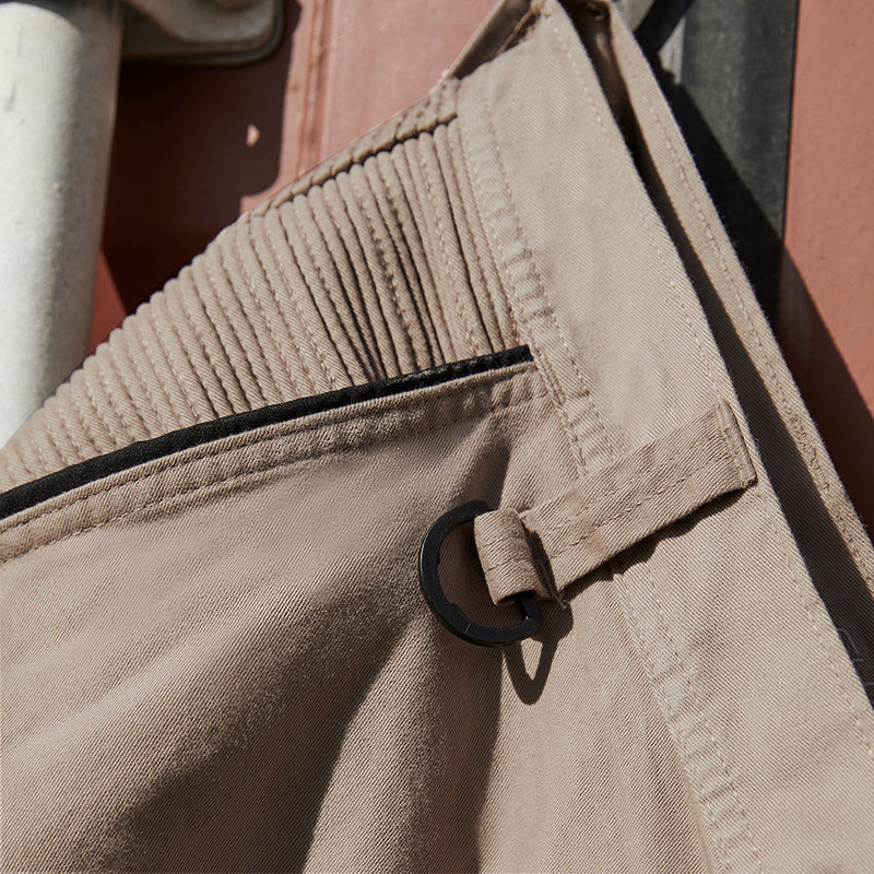Load image into Gallery viewer, Syzmik Streetworx Stretch Pant showcasing a close-up of a pocket with black bonded zips and a metal ring, emphasizing the pant’s functional design and modern slim fit for workplace safety.