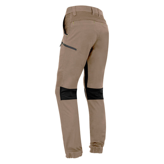 Syzmik Streetworx Stretch Pant featuring black patches, elastic cuff hems, and multiple pockets with black bonded zips. Ideal for workplace safety and comfort, emphasizing functionality and modern design.