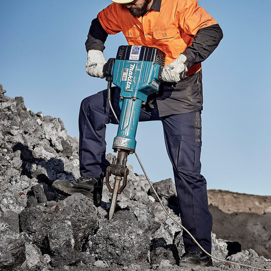 Syzmik Basic Cargo Pant, Navy, showcasing durable 100% cotton drill fabric with eight functional pockets, including two large cargo pockets, reinforced stress points, and adjustable waistband tabs, ideal for workplace safety and utility.
