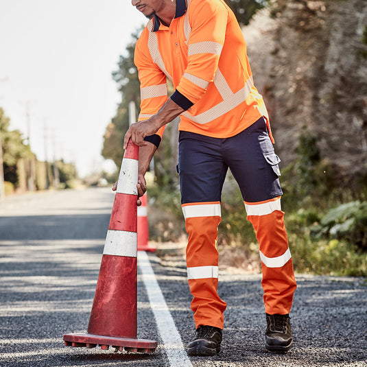 Syzmik Hi Vis Bio Motion Taped Pant showcasing a sturdy cotton drill with enhanced visibility features, including bio motion tape and multiple functional pockets, ideal for safety-focused workplaces.