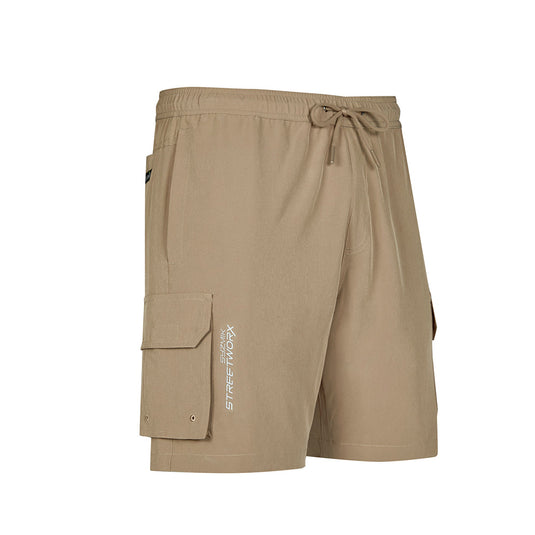 Syzmik Streetworx Stretch Board Short featuring a tan color, drawstring waist, cargo and mobile phone pockets with drainage holes, and reflective branding, designed for comfort and durability in active work environments.