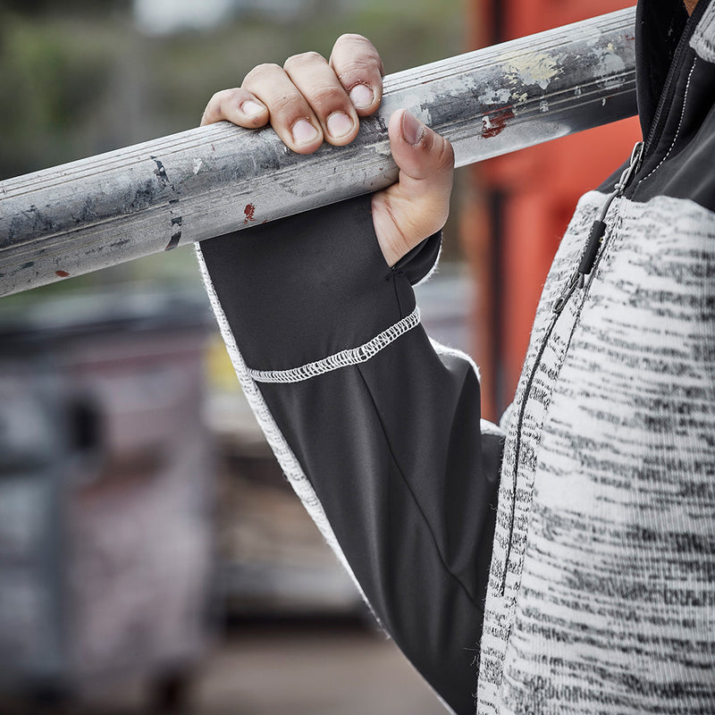 Load image into Gallery viewer, Syzmik Streetworx Knit Hoodie being held, showcasing its durable knitted polyester fabric with reinforced panels and thumb hole cuffs, ideal for safety and workwear settings.