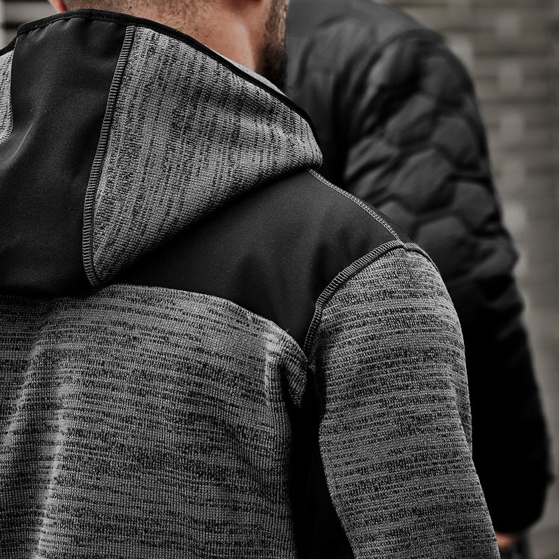 Load image into Gallery viewer, Syzmik Streetworx Knit Hoodie worn by a man, featuring a warm marle knitted fleece with reinforced soft shell panels and built-in glove cuffs, perfect for active safety and workwear needs.