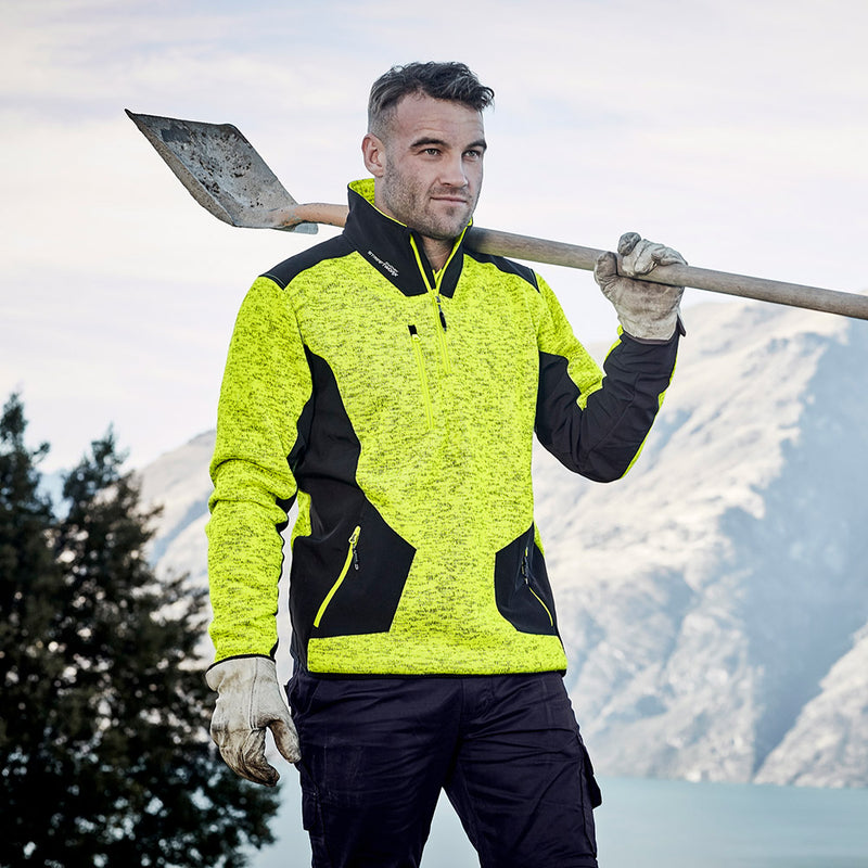 Load image into Gallery viewer, Syzmik Streetworx Reinforced 1/4 Zip Pullover worn by a man outdoors, showing the high neck and reinforced softshell panels, ideal for safety and work environments.