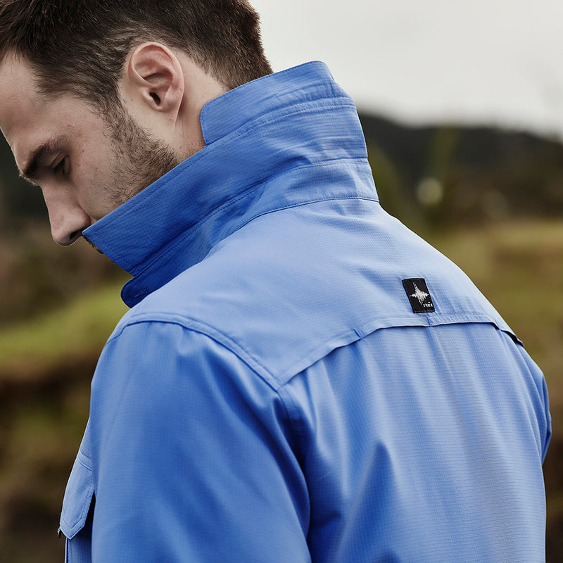 Load image into Gallery viewer, Syzmik Outdoor Ripstop Work Shirt on a bearded man, highlighting its lightweight, breathable fabric with extra-large underarm mesh, chest pockets, and modern fit, ideal for outdoor work environments.