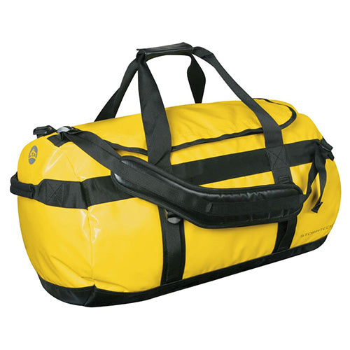 Load image into Gallery viewer, Stormtech Waterproof Gear Bag - Medium features a robust design with black straps, adjustable padded shoulder straps, and an ID pocket, ideal for keeping essentials dry for work or outdoor activities.