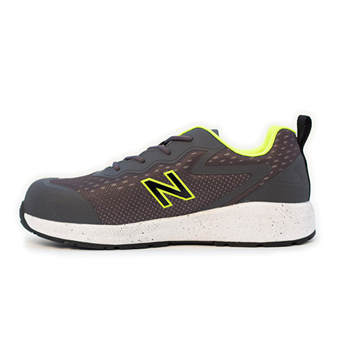 New Balance Logic Safety Shoe, Grey/Lime, features a sleek design with a visible composite toe and slip-resistant outsole, ideal for workplace safety and comfort.