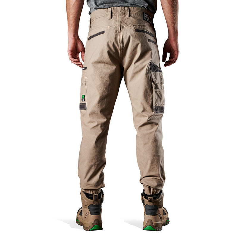 Load image into Gallery viewer, FXD WP-4 Stretch Cuffed Work Pants worn by a man, showcasing their elastic cuffed ankles and durable pocket panels, ideal for comfort and movement in active work environments.