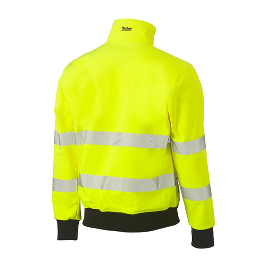 Bisley Hi Vis Soft Shell Bomber Jacket, back view, showcasing fluorescent yellow fabric with reflective silver bands, black ribbed cuffs and hem, and Bisley Workwear logo on the collar, emphasizing safety and durability.