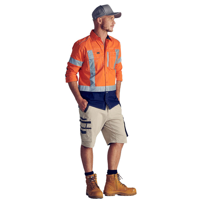 Man wears Bisley Flex & Move Stretch Utility Zip Cargo Shorts, featuring multiple pockets and a durable design with Cordura® in high-stress areas, perfect for workplace safety and comfort.