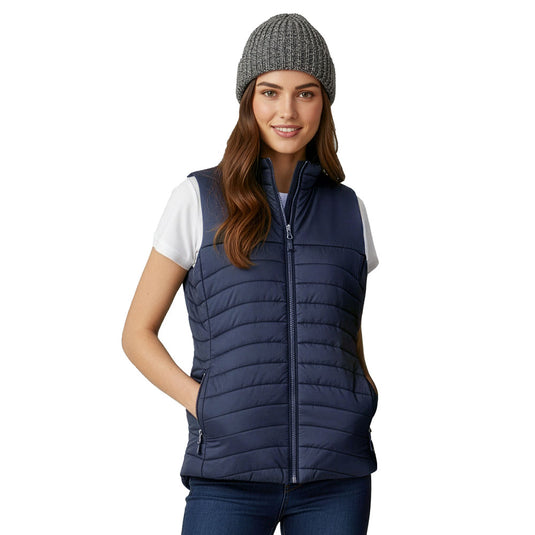 Biz Womens Expedition Vest modeled in a casual outdoor style, showcasing its lightweight design, high collar, and zippered pockets. Perfect for staying warm without bulk, ideal for active settings.