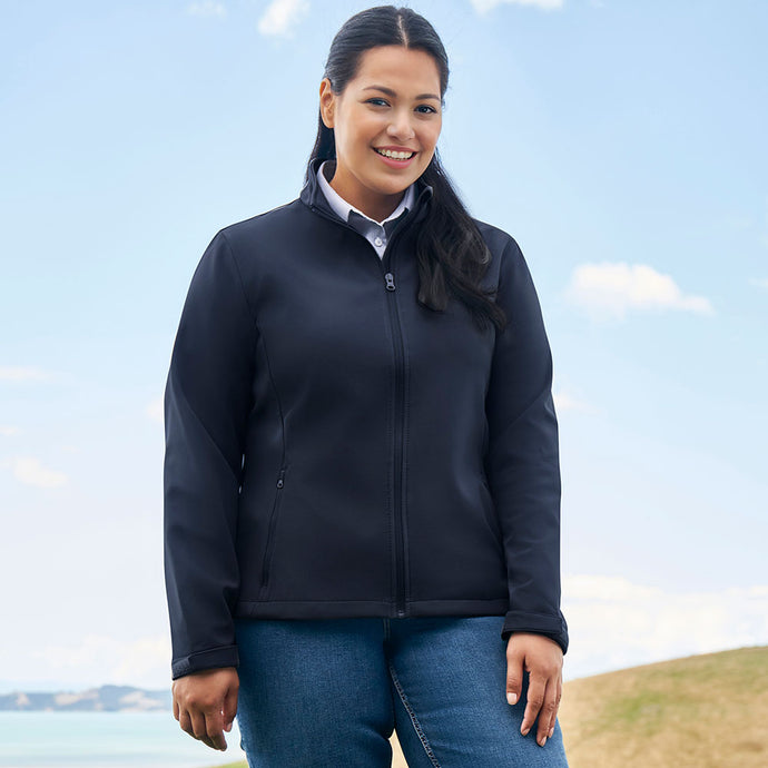 Close-up of a woman smiling, showcasing the Biz Apex Ladies Lightweight Softshell Jacket's stand-up collar and scalloped back, ideal for versatile weather protection in corporate or team environments.