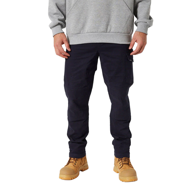 Load image into Gallery viewer, Jetpilot Fueled Utility Pant with flap pocket, visible articulated knees, and tan work-style boots, showcases performance stretch and durability, ideal for active workwear.
