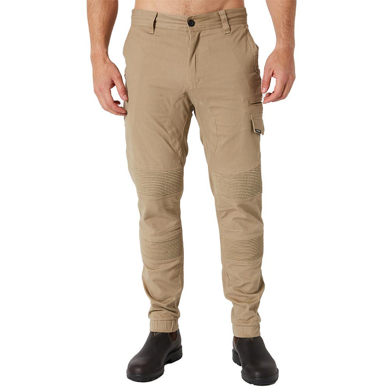 Load image into Gallery viewer, Jetpilot Fueled Corrugated Stretch Pant features ribbed knee panels, multiple pockets including a thigh cargo pocket, elasticized cuffs, and reinforced knees, paired with dark brown work boots, ideal for active work environments.
