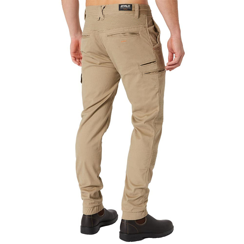 Load image into Gallery viewer, Back view of Jetpilot Fueled Corrugated Stretch Pant, featuring slim-fit design with articulated knees, reinforced stitching, and multiple engineered pockets. Worn with dark brown work boots, highlighting durable workwear style.
