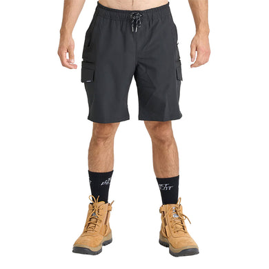 Jetpilot Jet Lite Hybrid 20 Utility Short features black cargo-style design with elastic drawstring waistband, flap thigh pockets, black crew socks, and tan suede work boots, reflecting durability and functionality.