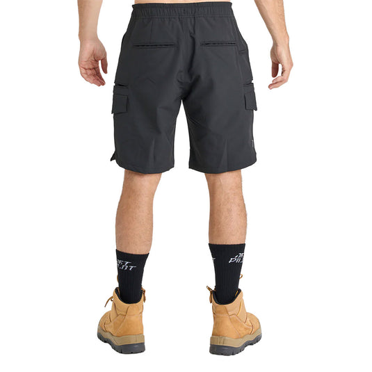 Person wearing Jetpilot Jet Lite Hybrid 20 Utility Short, showcasing side flap pockets, elastic waistband, and tan work boots, exemplifying practicality and durability for a safety-focused work environment.