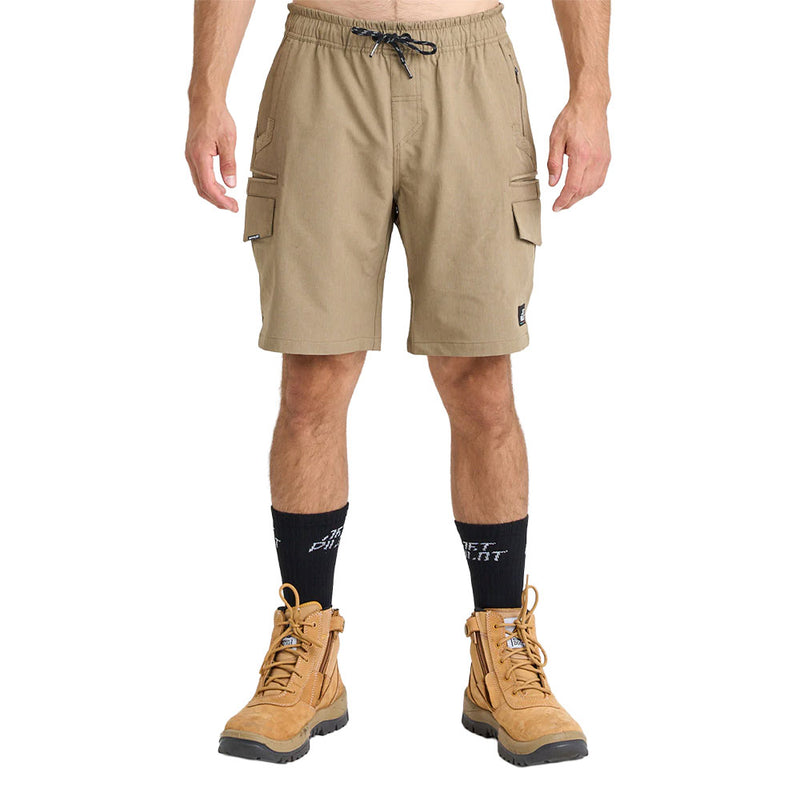 Load image into Gallery viewer, Model wearing Jetpilot Jet-Lite Hybrid 20 Utility Short, showcasing knee-length khaki cargo shorts with elastic waistband, flap thigh pockets, and rugged tan work boots, ideal for active, safety-focused work environments.
