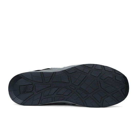 Underside view of the New Balance Elite Lite Safety Shoe, showcasing its treaded rubber sole with a visible NB logo, highlighting slip resistance and durability for light-duty workplace conditions.