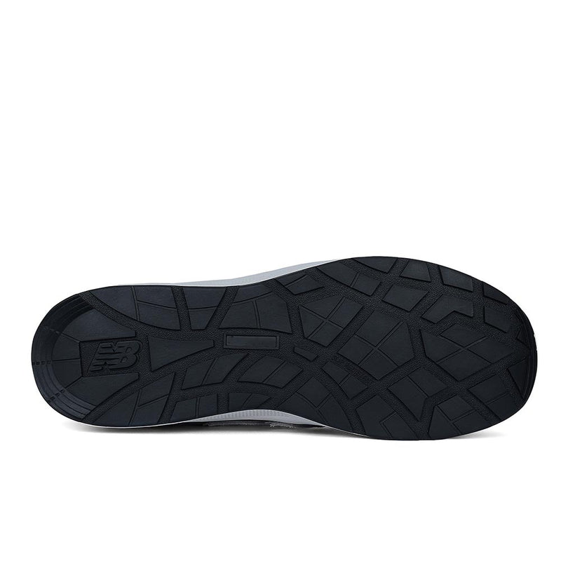 Load image into Gallery viewer, Underside view of the New Balance Elite Lite Safety Shoe, Grey/White, showcasing its black rubber outsole with a tread pattern and NB logo, highlighting slip resistance and durability for workplace safety.
