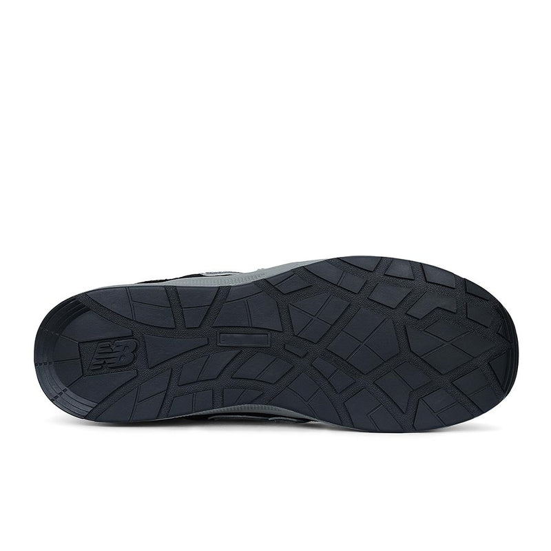 Load image into Gallery viewer, New Balance Elite Lite Womens Safety Shoe features a dark rubber outsole with geometric tread and “NB” logo, highlighting slip resistance and safety, ideal for light industrial use.
