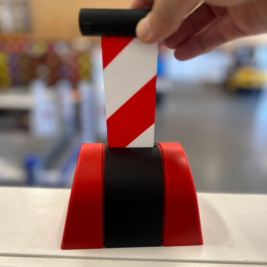 Wall Mounted Red/White Retractable Belt, 5m, with a red and black plastic dispenser, showing the striped belt extended. Ideal for crowd control or hazard marking, fitting Active Safety's reliable workplace solutions.