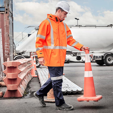 Syzmik Hi Vis TTMC-W23 X Back PU Rain Jacket features a durable waterproof design with an adjustable hood, storm cuffs, and reflective tape, ideal for workplace safety and protection.