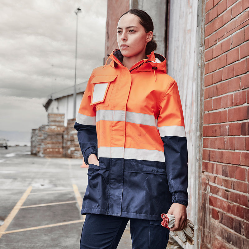Load image into Gallery viewer, Syzmik Womens Ultralite Waterproof Jacket features seam-sealed 100% Oxford Polyester, reflective tape, and concealed adjustable hood, designed for optimal fit and rain protection, ideal for active safety environments.
